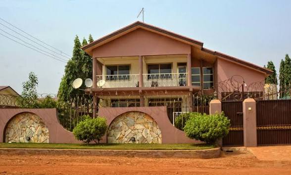 Residential family house with stone arch fence in Ghana